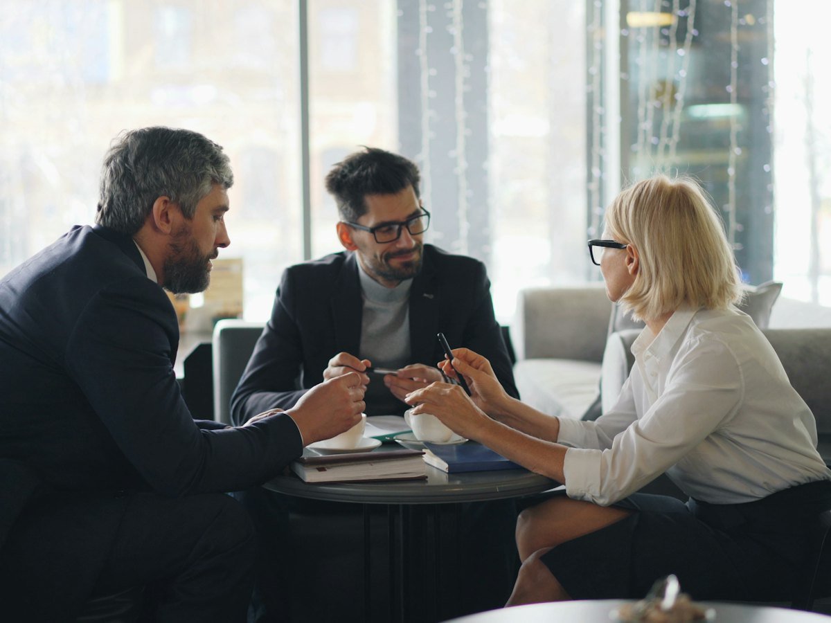 People reviewing paperwork together around a table